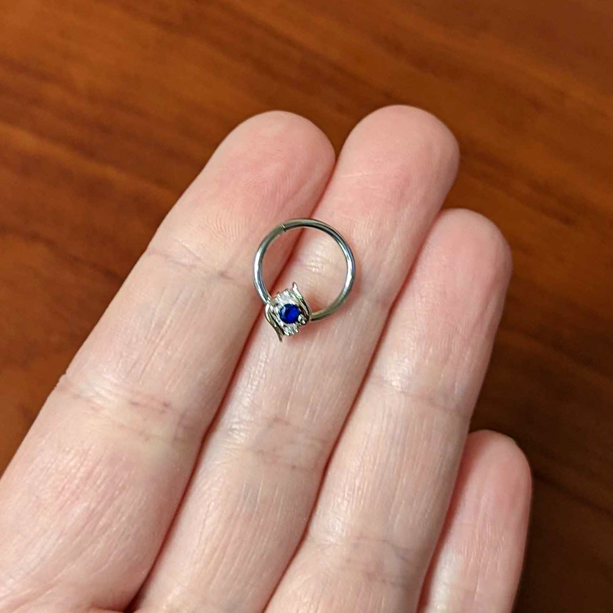 16G 3/8 Clear Blue Gem Oval Swirl Hinged Segment Ring